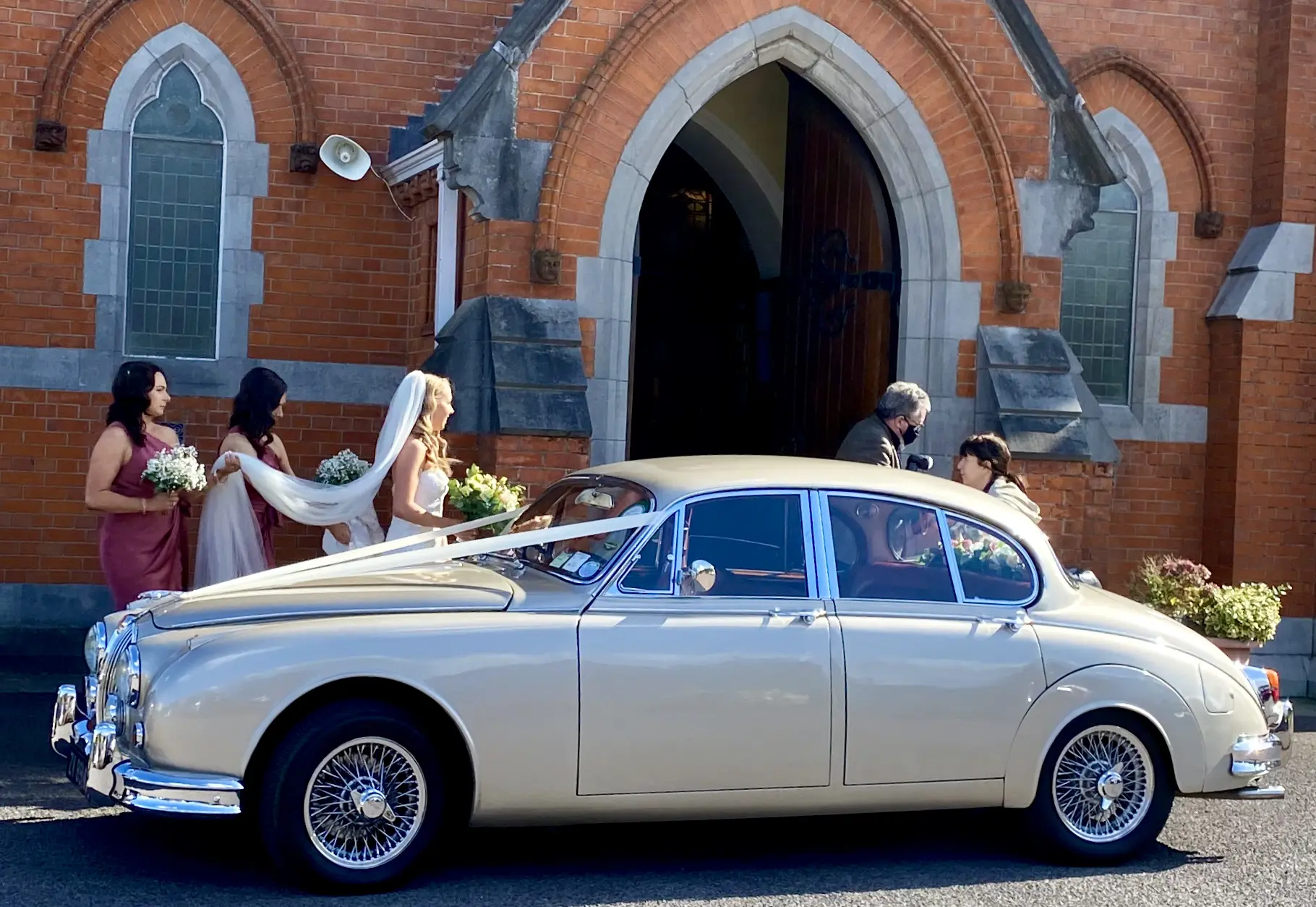 A Classic Mk II Jaguar wedding car at Donabate Church, Dublin
